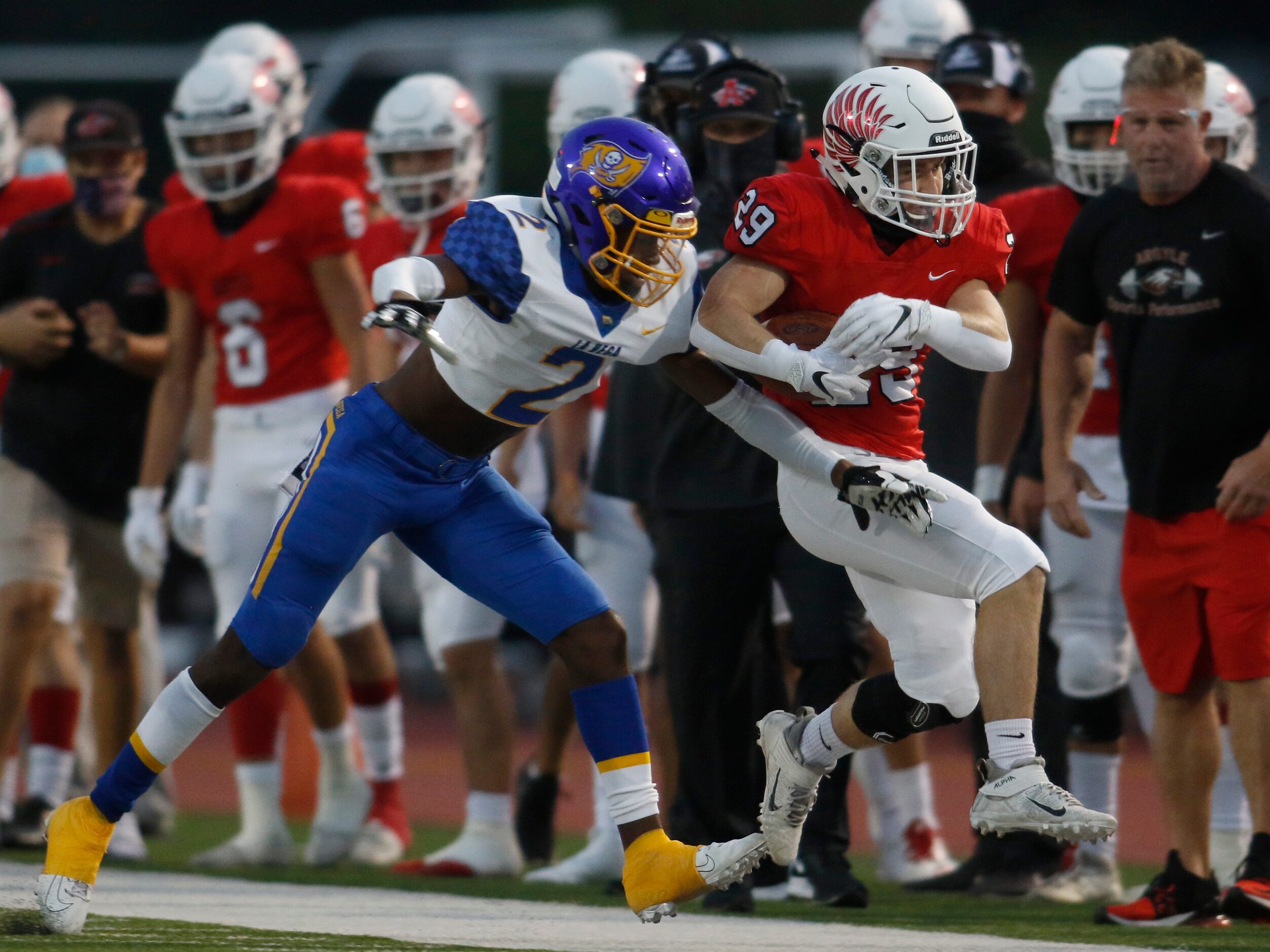 Argyle running back Braden Baker (29) scampers down the team sideline before being knocked...