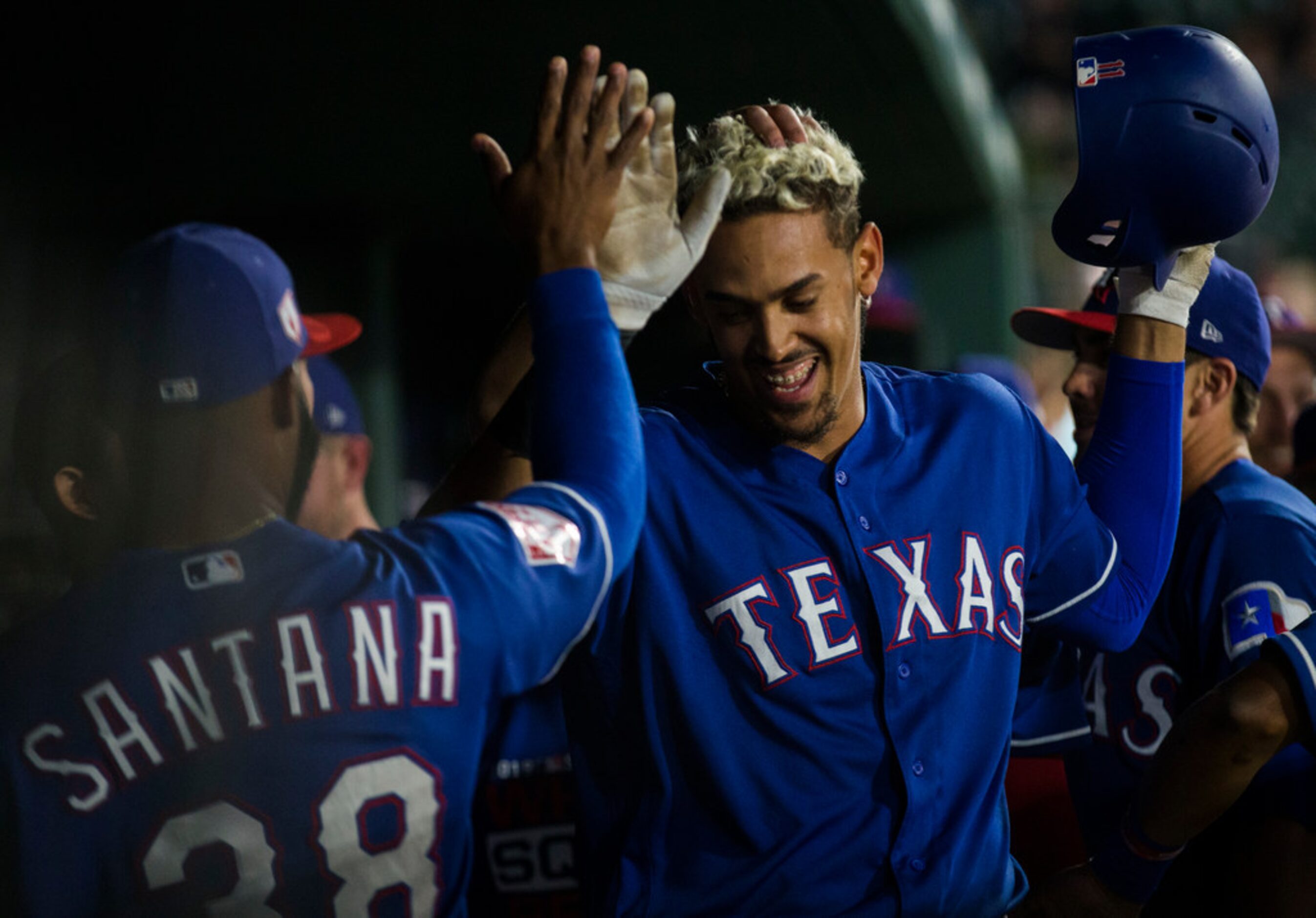 Texas Rangers first baseman Ronald Guzman (11) celebrates after a home run during the fifth...