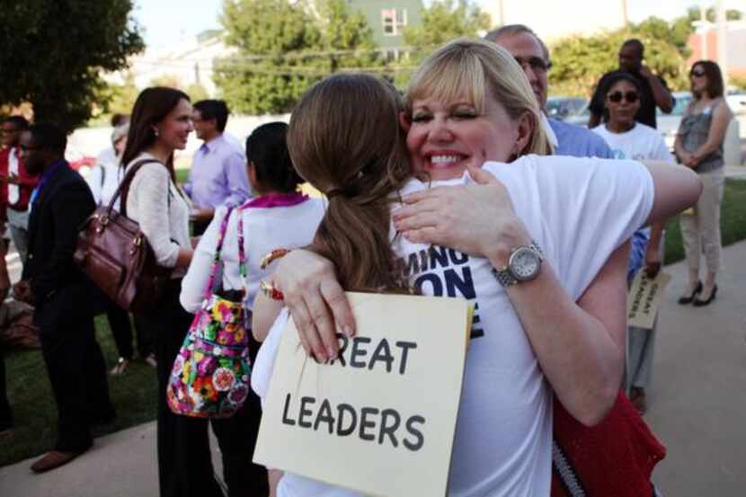 
Regina Bruce hugs teacher Eleonore O'Donnell after she gave remarks at the Rally for...