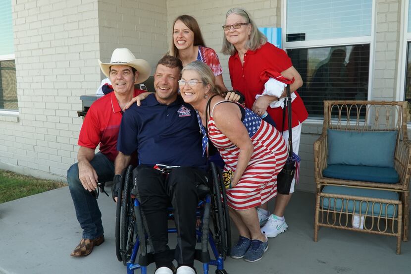 Veteran Jonathan Merchant (in wheelchair) with his family at the home in Northlake donated...