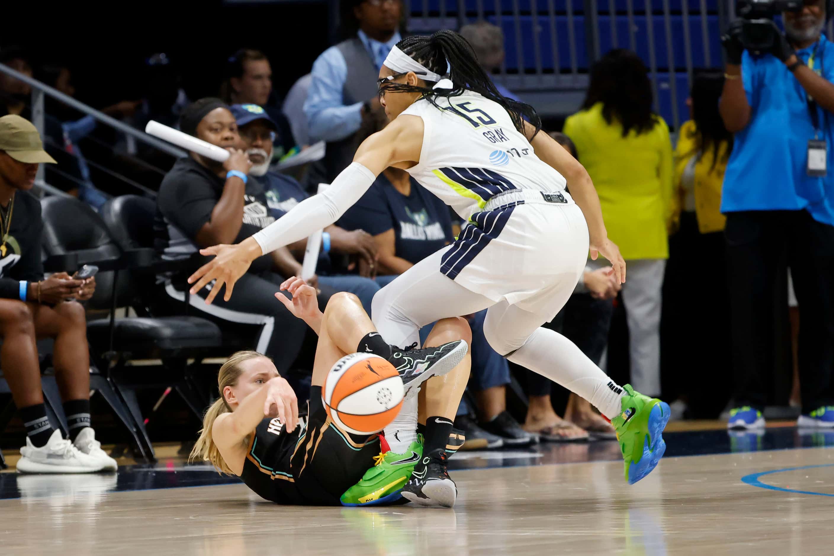 New York Liberty's Marine Johannes, left, passes the ball while on her back in front of...
