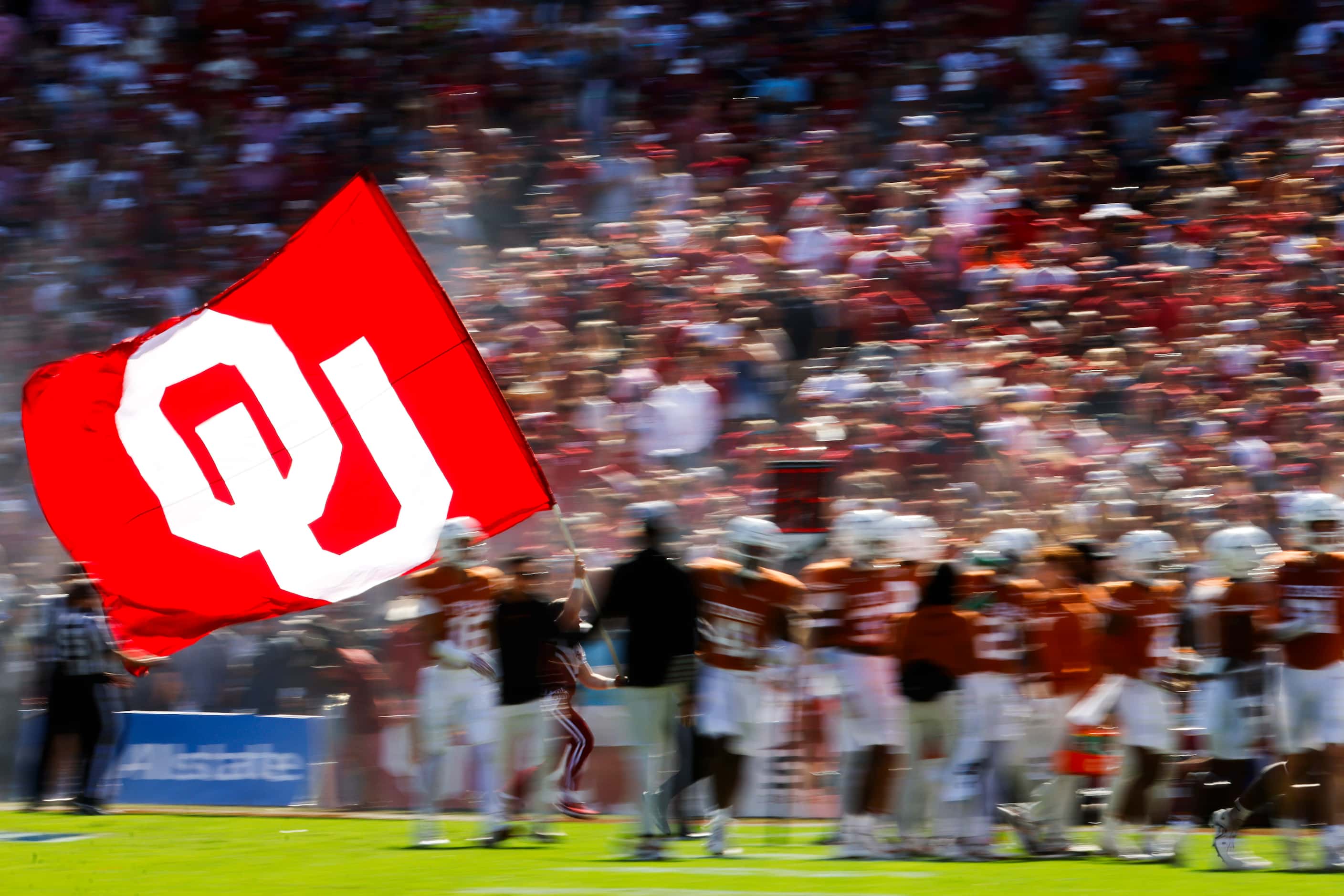 Oklahoma flag runs through the field after a touchdown during the Red River Rivalry at the...