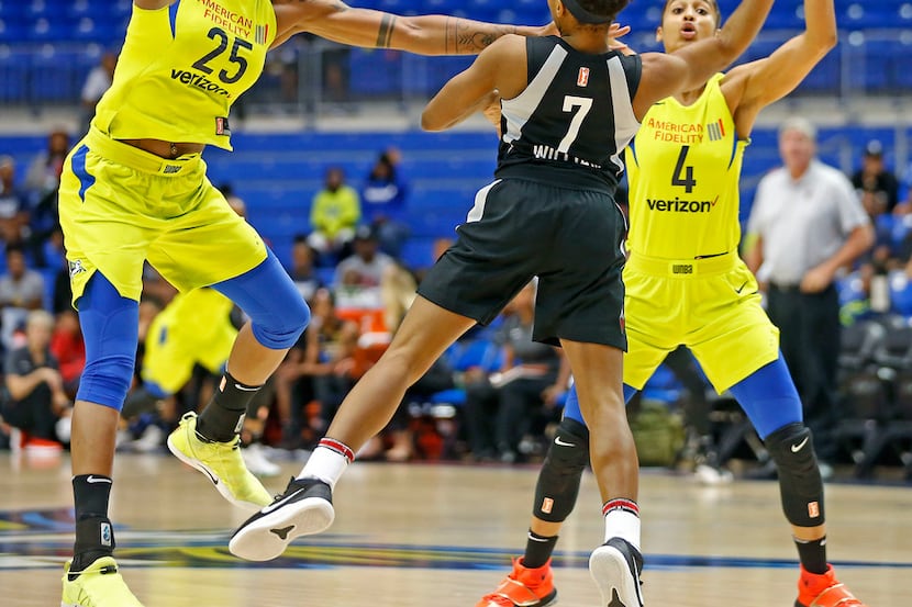 Las Vegas Aces guard Morgan William (7) is defended by Dallas Wings forward Glory Johnson...