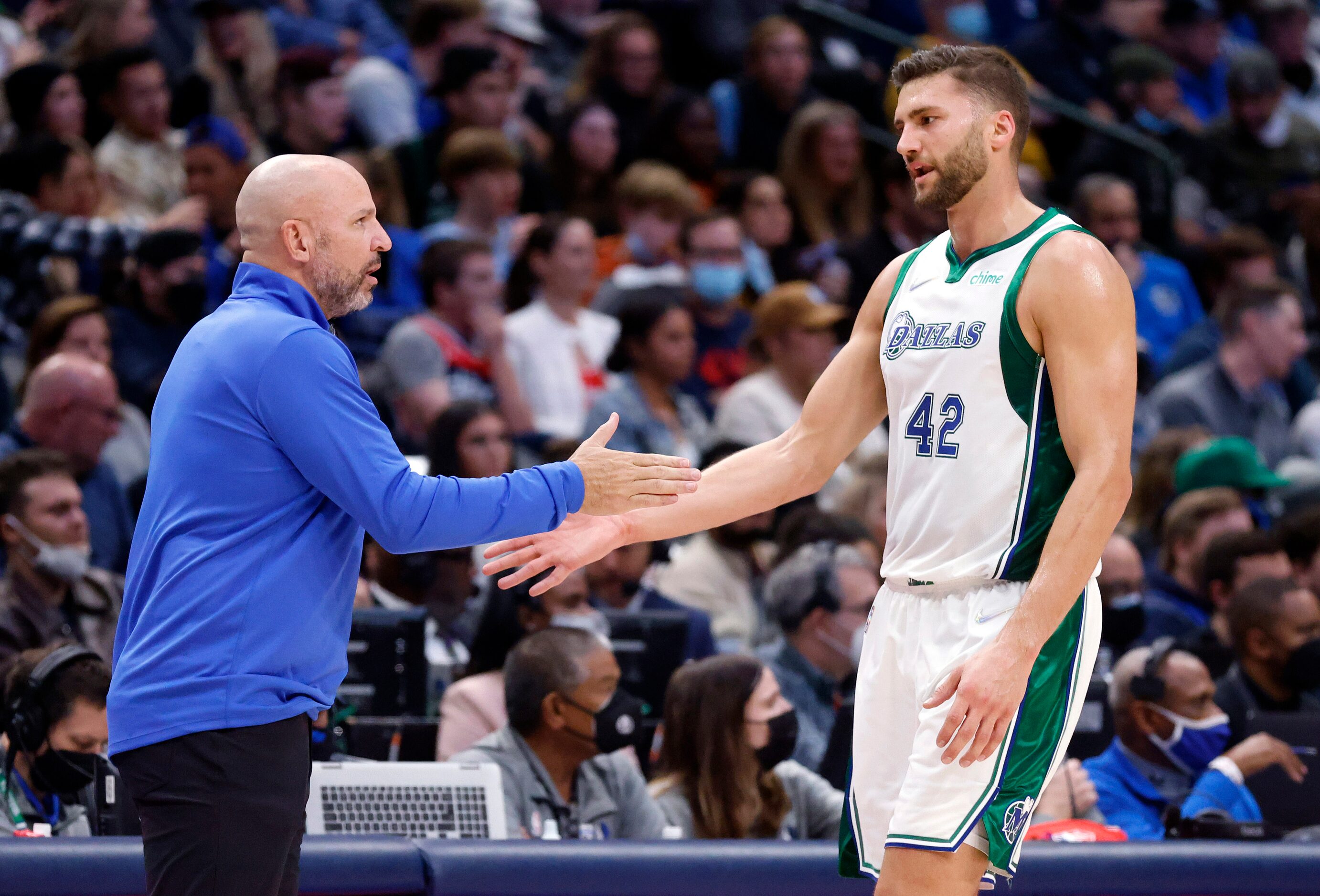 Dallas Mavericks head coach Jason Kidd slaps hands with forward Maxi Kleber (42) as he comes...