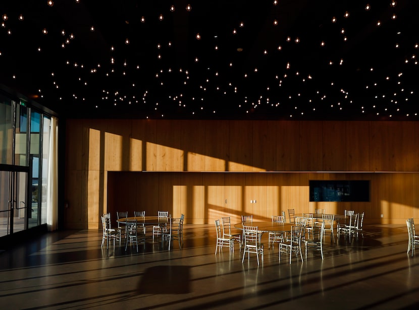 Star-cluster ceiling lights run the length of an event space at the St. Sarkis community...