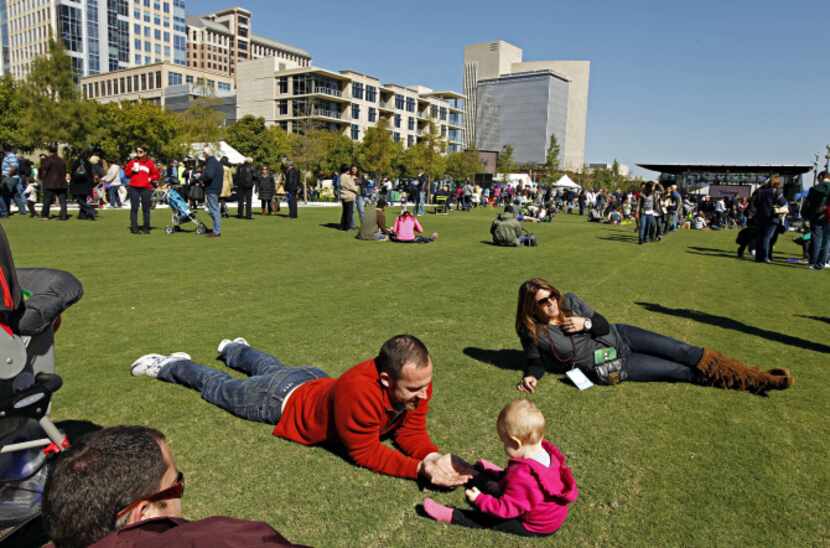 Matt Baker (left) plays with his 11-month-old daughter, Kate Baker, during opening...