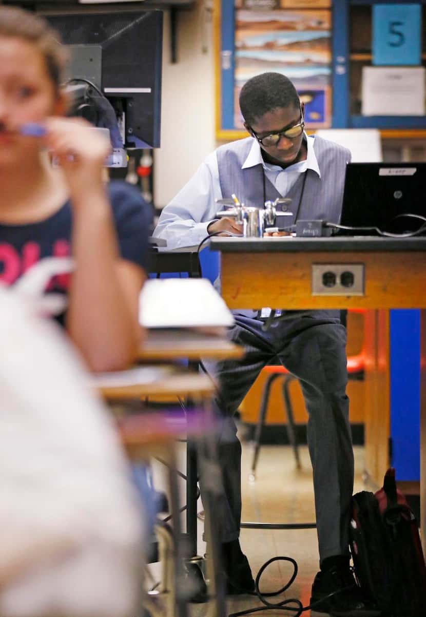 
Lee Kamara sits in the back of the classroom by the electric magnifying viewer during...