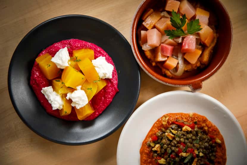 A collection of meze:  Shown (clockwise from left) are yellow beets with red beet hummus,...