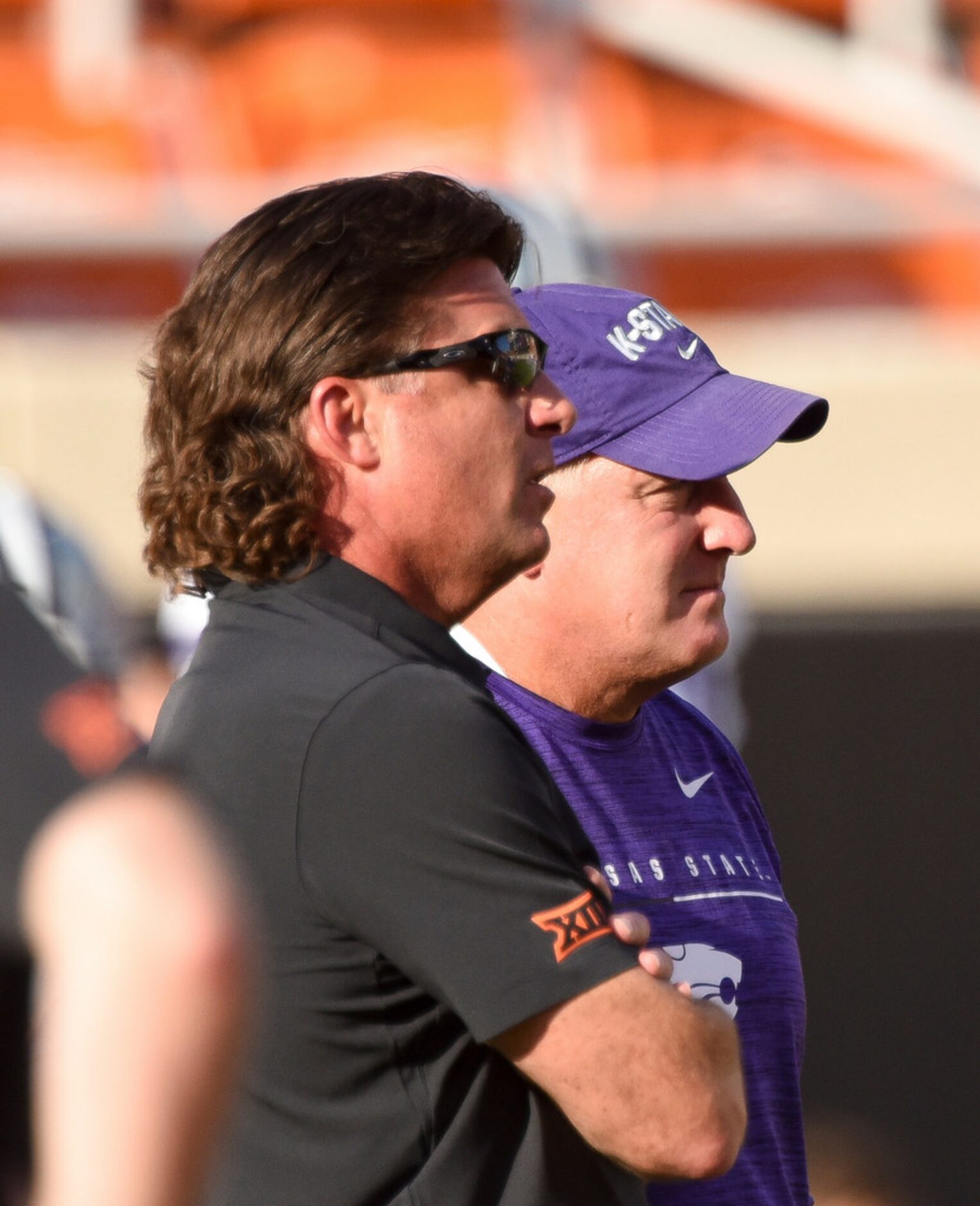 Oklahoma State head coach Mike Gundy, left, talks with Kansas State head coach Chris Klieman...