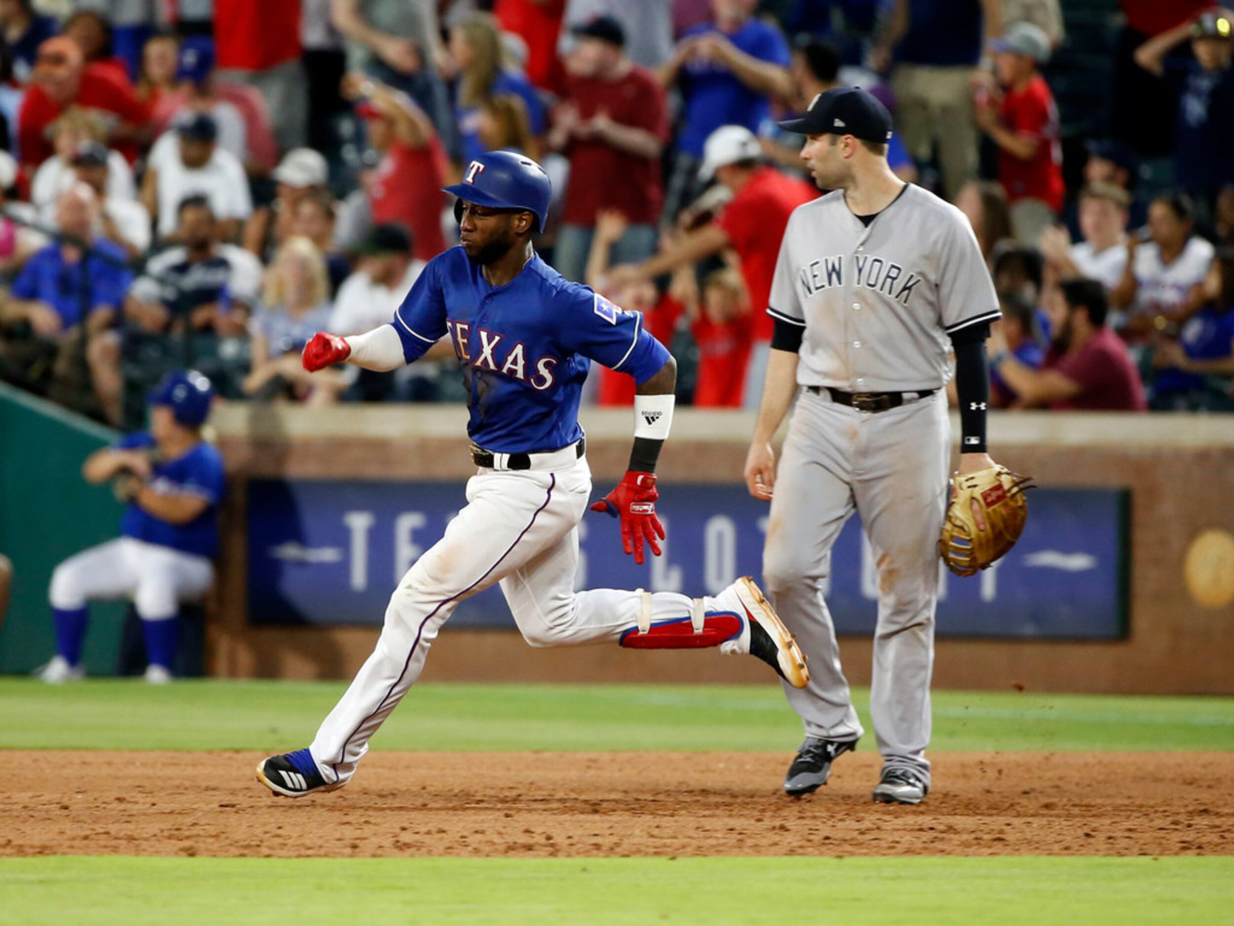 Texas Rangers' Jurickson Profar (19) runs past New York Yankees first baseman Neil Walker on...