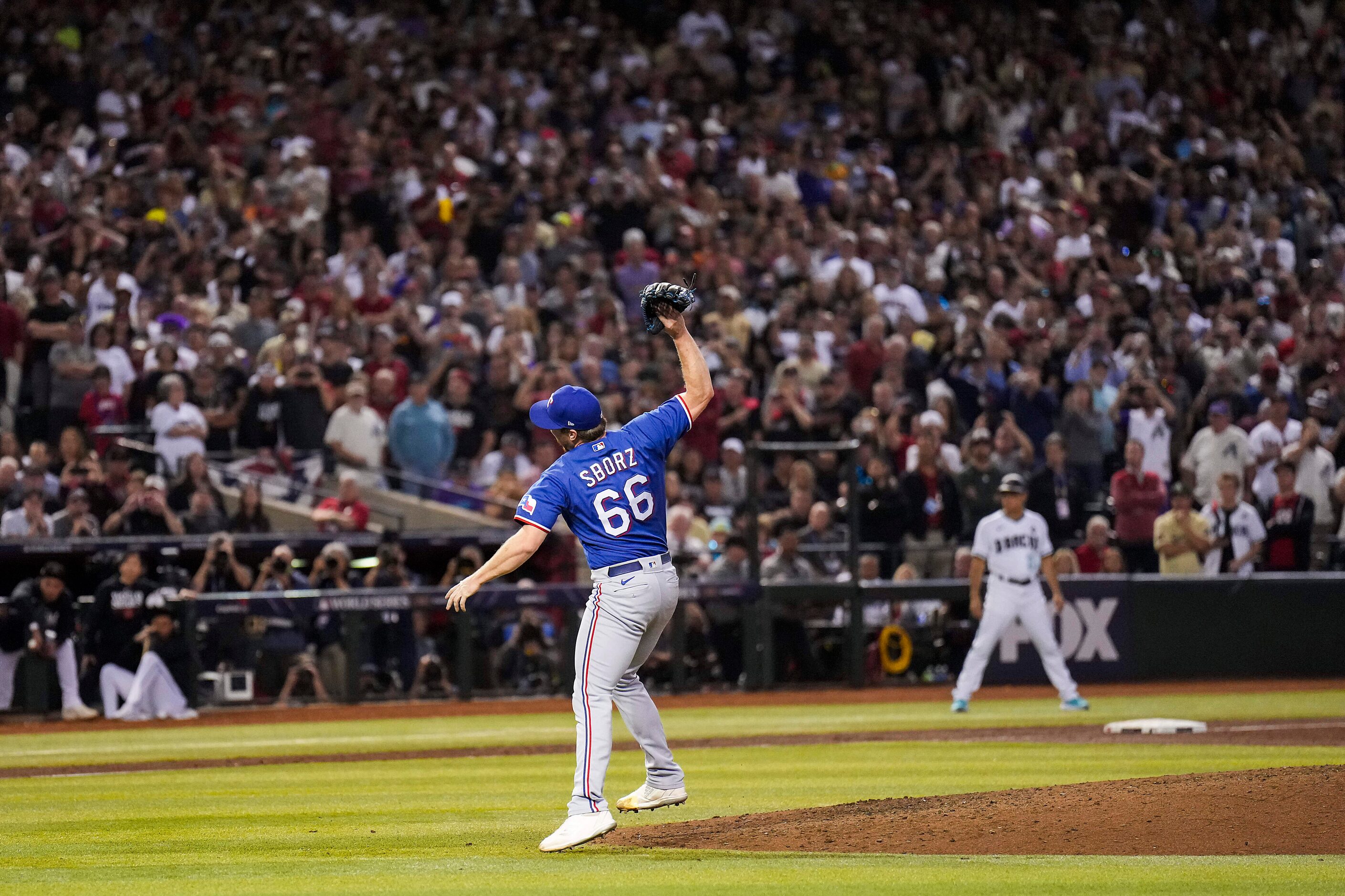 Texas Rangers relief pitcher Josh Sborz tosses his glove as he celebrates the final out in...