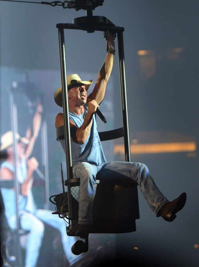 Country music recording artist flies high over a capacity stadium filled with fans. Chesney...