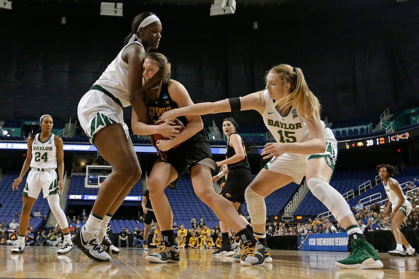Iowa's Amanda Ollinger, center, is tied up by Baylor's Lauren Cox, right, and Kalani Brown,...