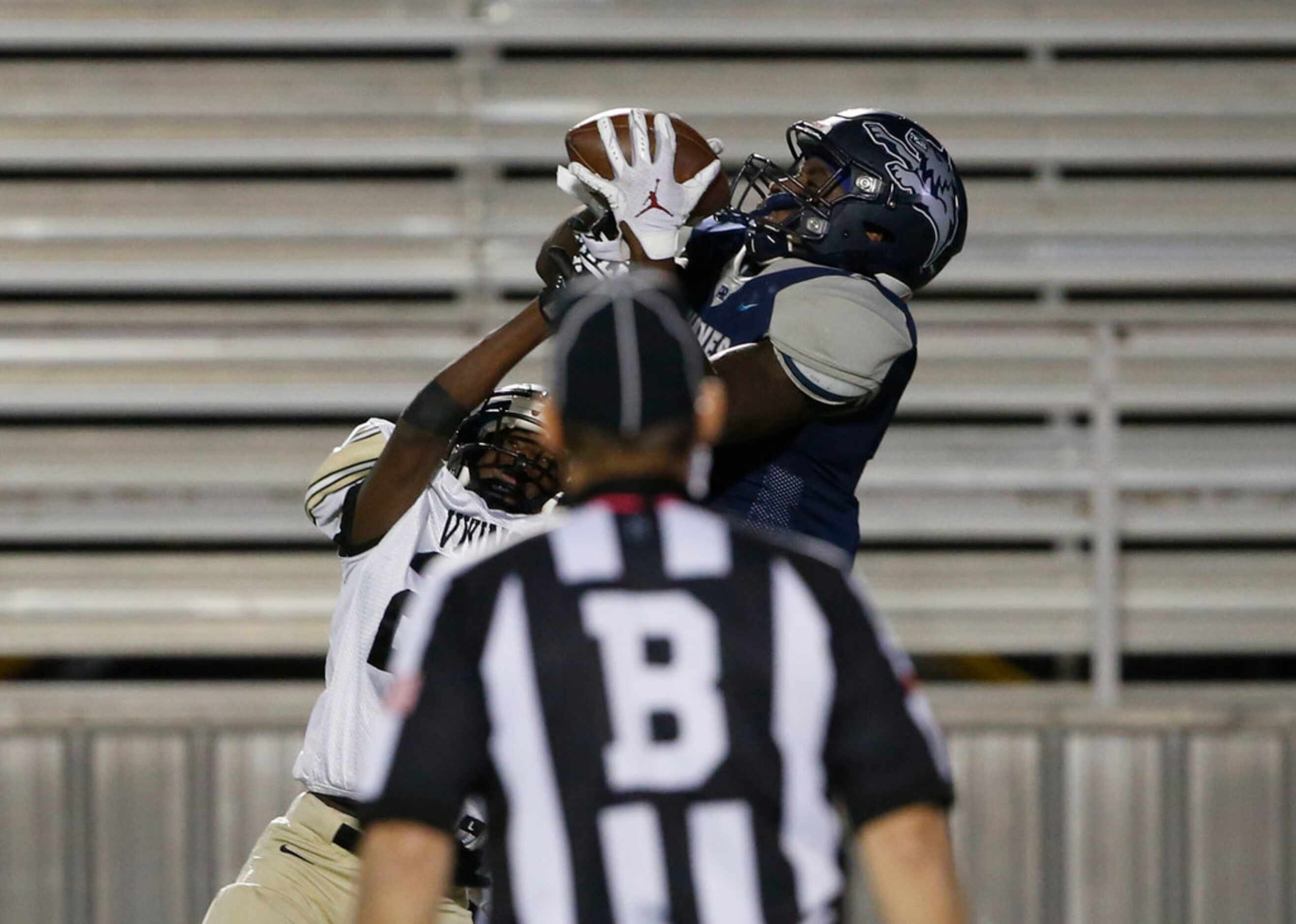 A back judge watches as Ranchview's Michael Henderson grabs a touchdown pass in front of...