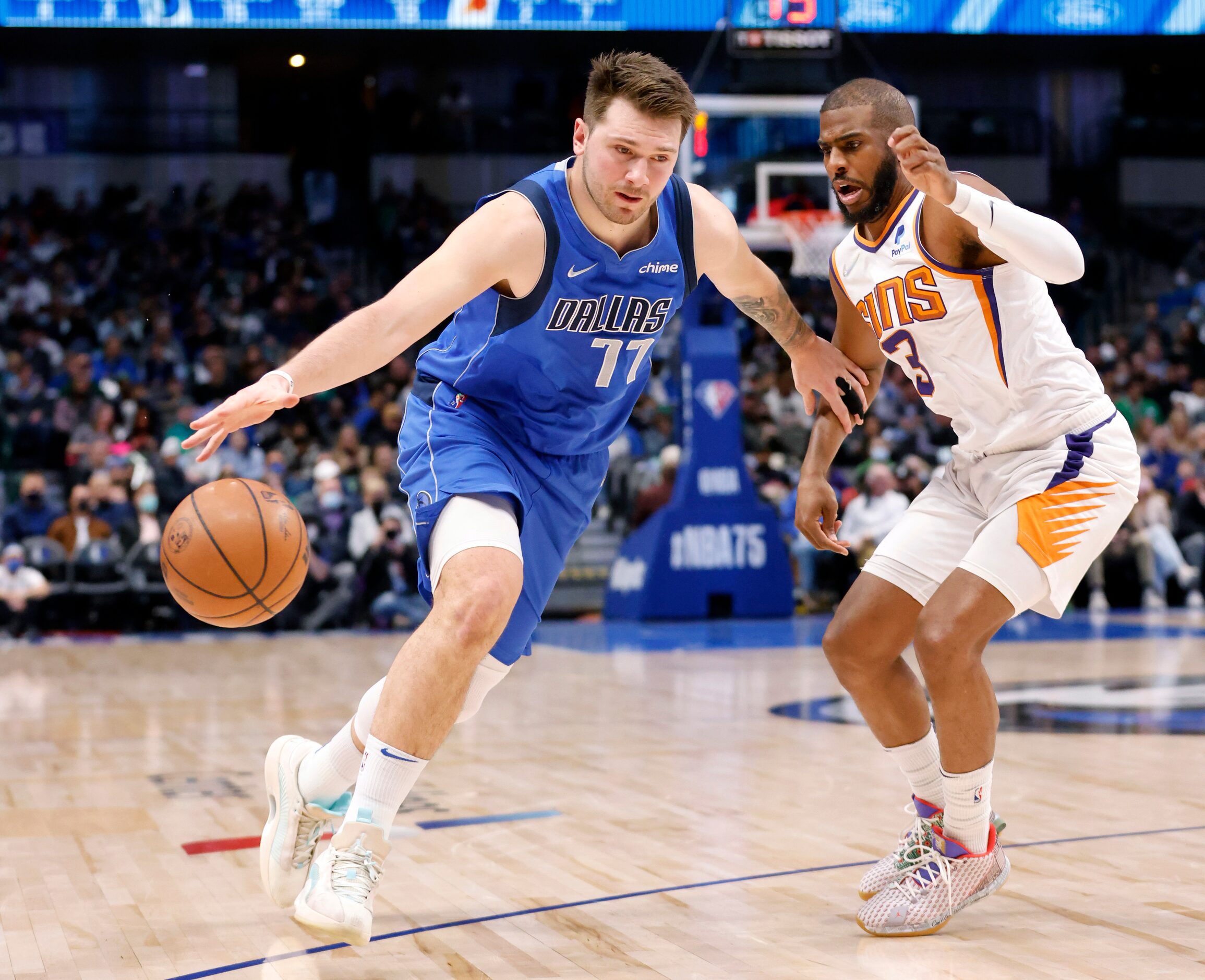 Dallas Mavericks guard Luka Doncic (77) drives the ball on Phoenix Suns guard Chris Paul (3)...