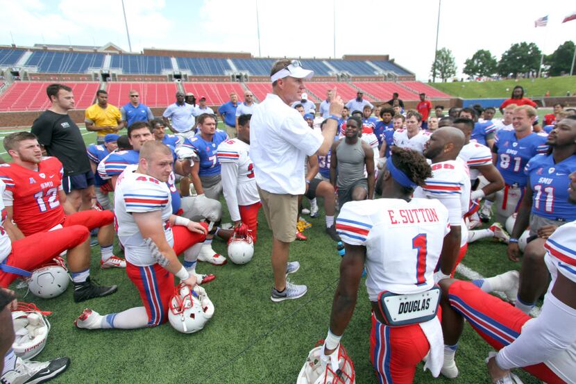 SMU Mustangs head football coach Chad Morris speaks with his players at the conclusion of...