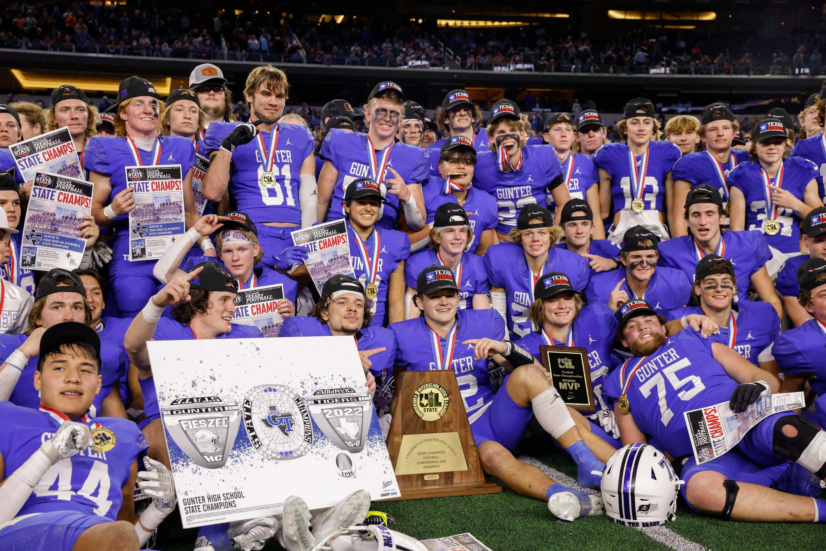 Gunter players pose after winning the Class 3A Division II state championship game at AT&T...