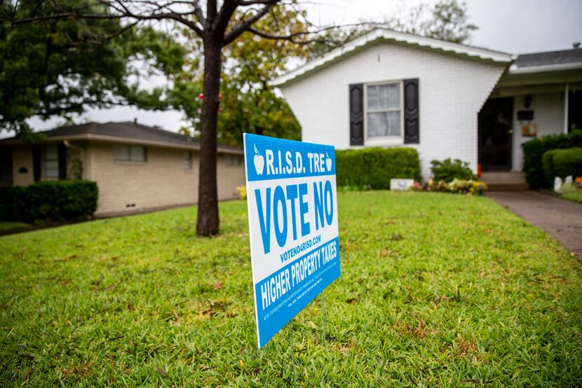 A sign opposing the proposed 13-cent tax rate increase on the November ballot sits in front...