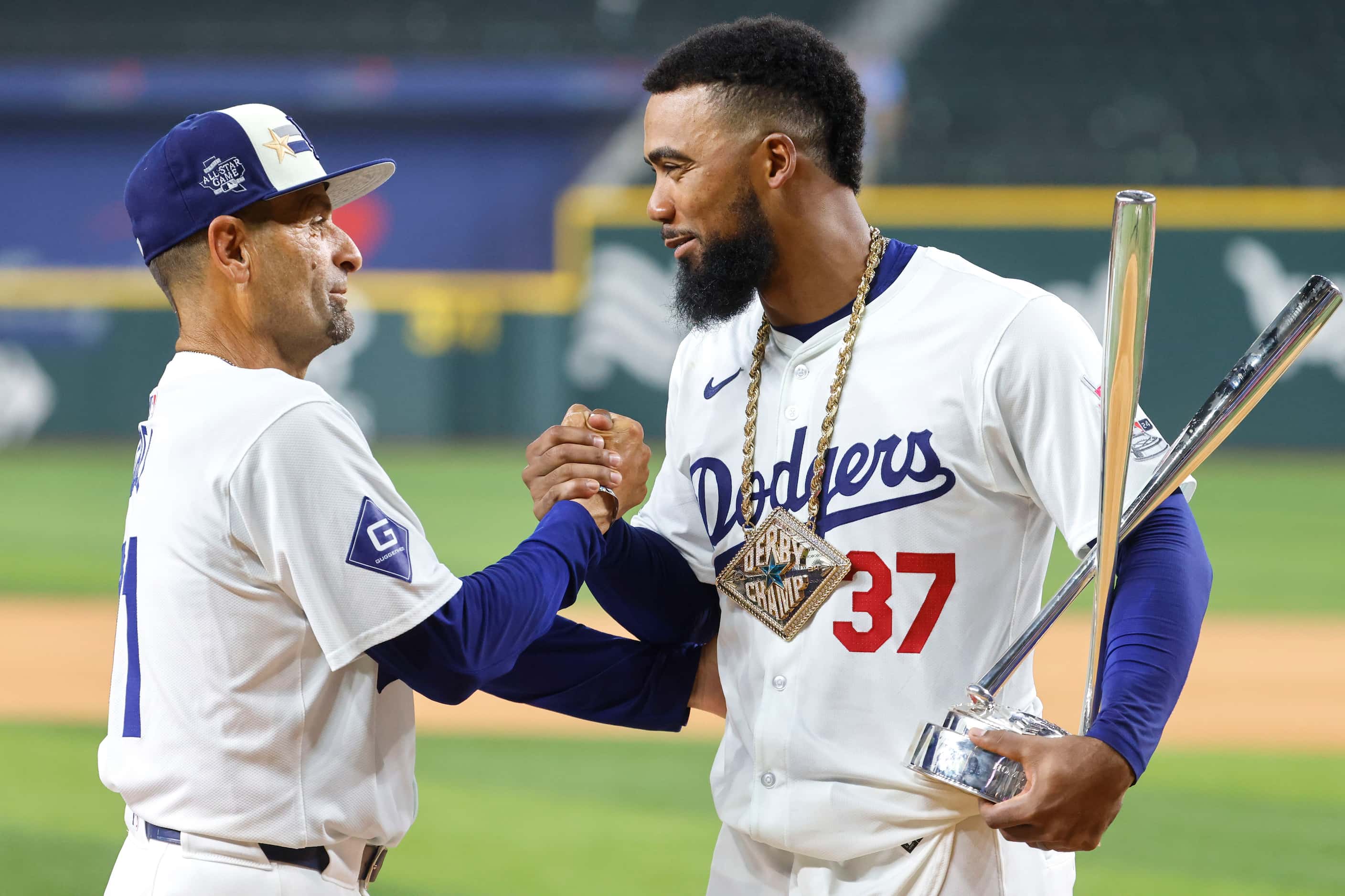 National League's Teoscar Hernández, of the Los Angeles Dodgers (left), shakes hand with...