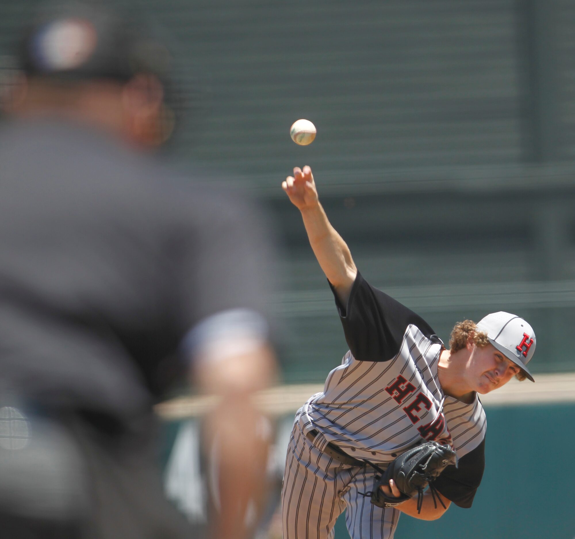 Rockwall Heath pitcher Baylor Baumann (1) delivers a pitch to a Rockwall batter during the...