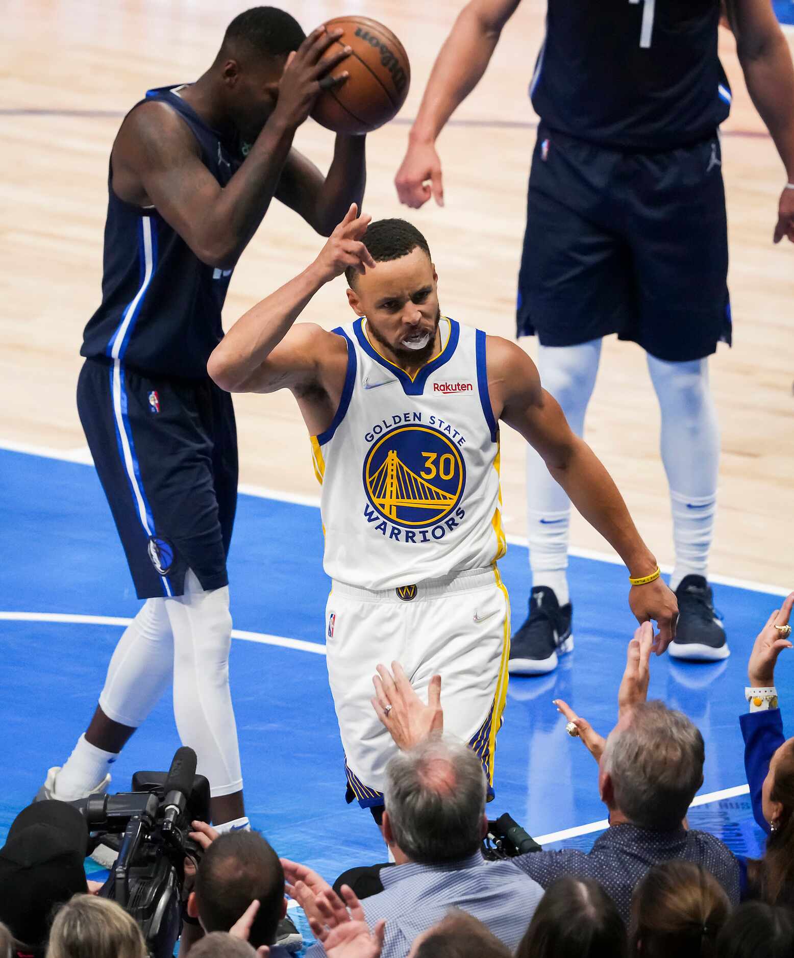 Golden State Warriors guard Stephen Curry (30) celebrates a basket and a foul past Dallas...