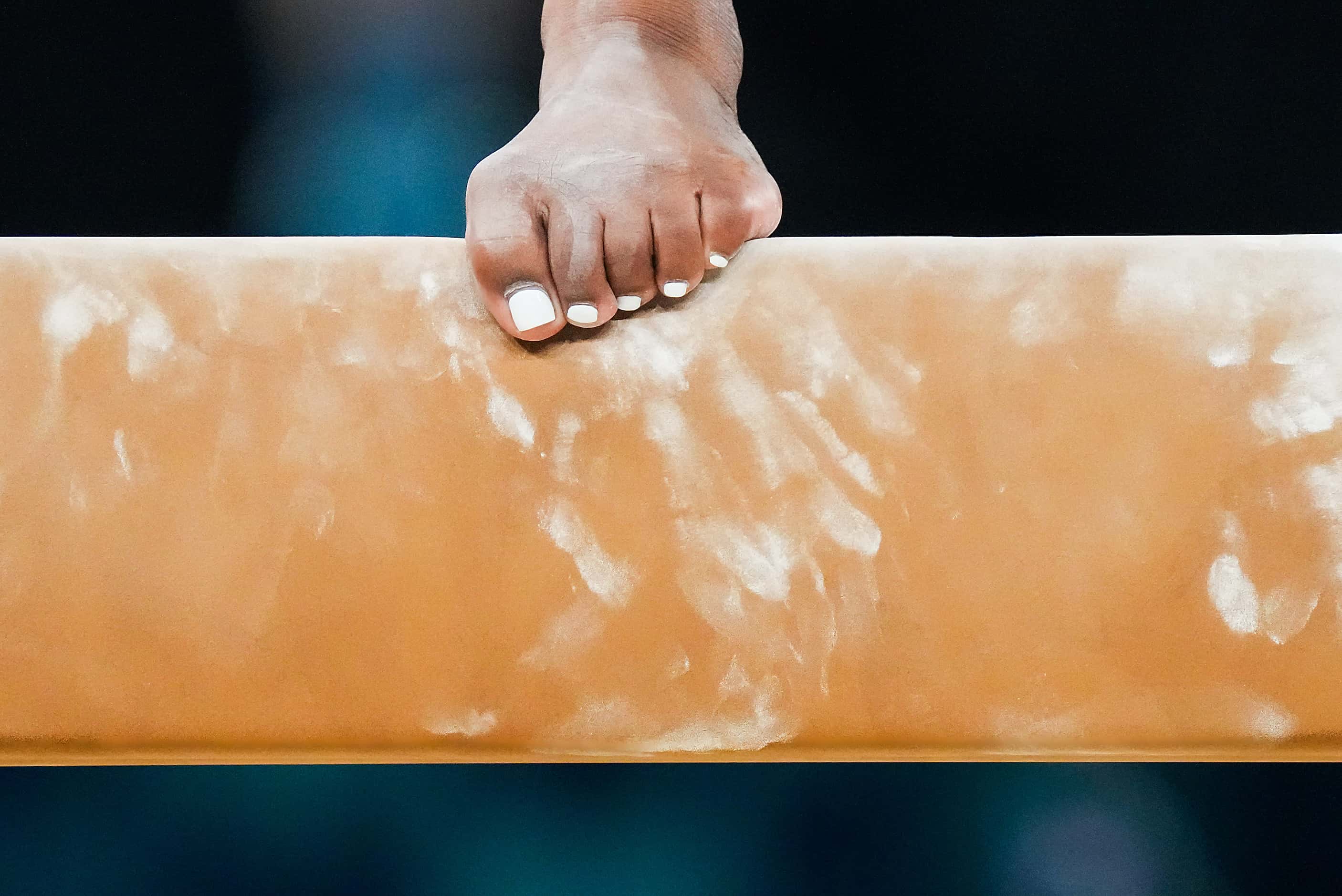 Simone Biles of the United States practices on the balance beam during women’s gymnastics...