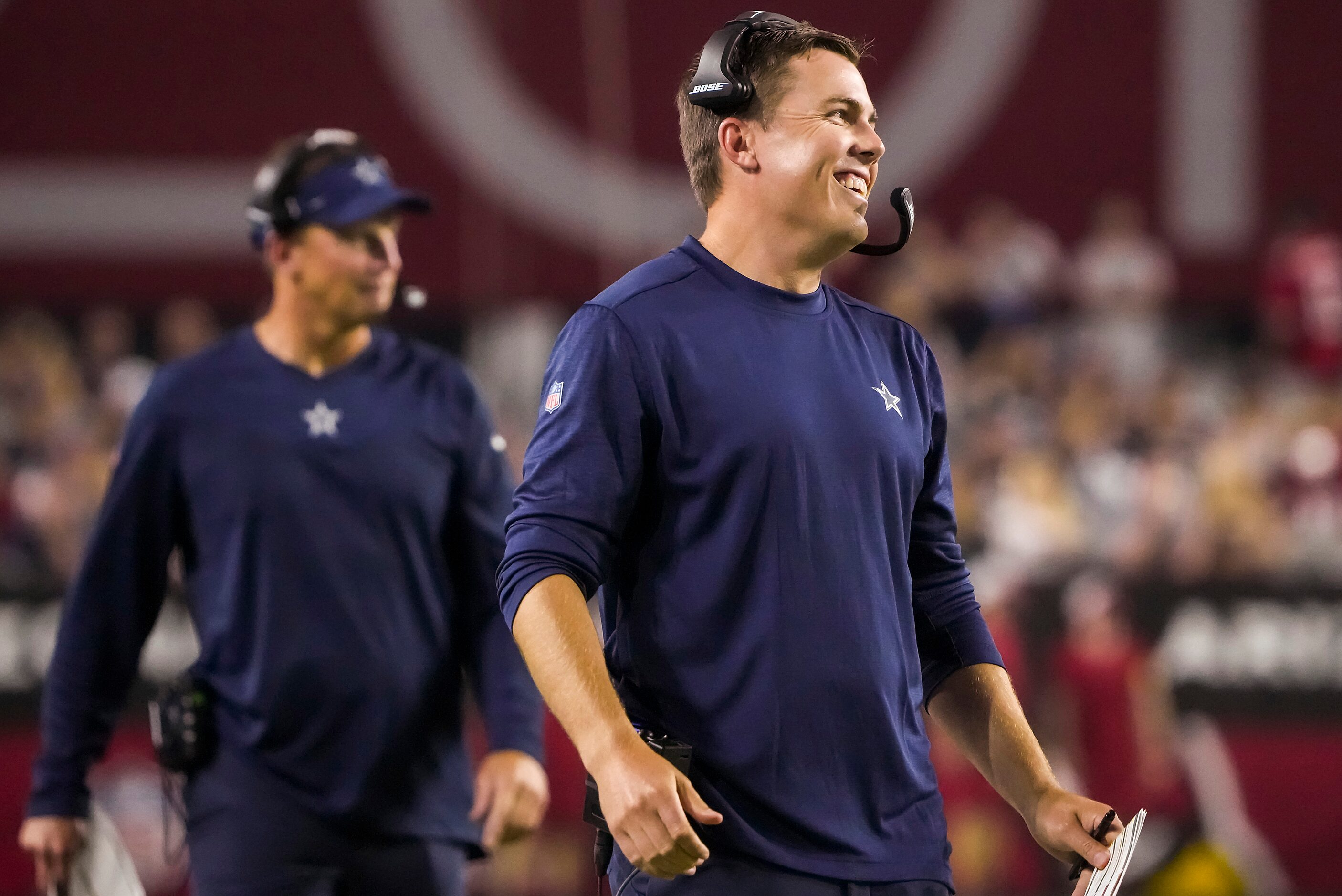 Dallas Cowboys offensive coordinator Kellen Moore smiles on the sidelines during the second...