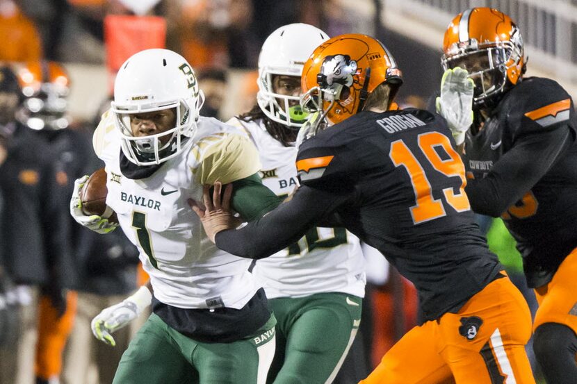 Baylor wide receiver Corey Coleman (1) pushes away from Oklahoma State place kicker Ben...