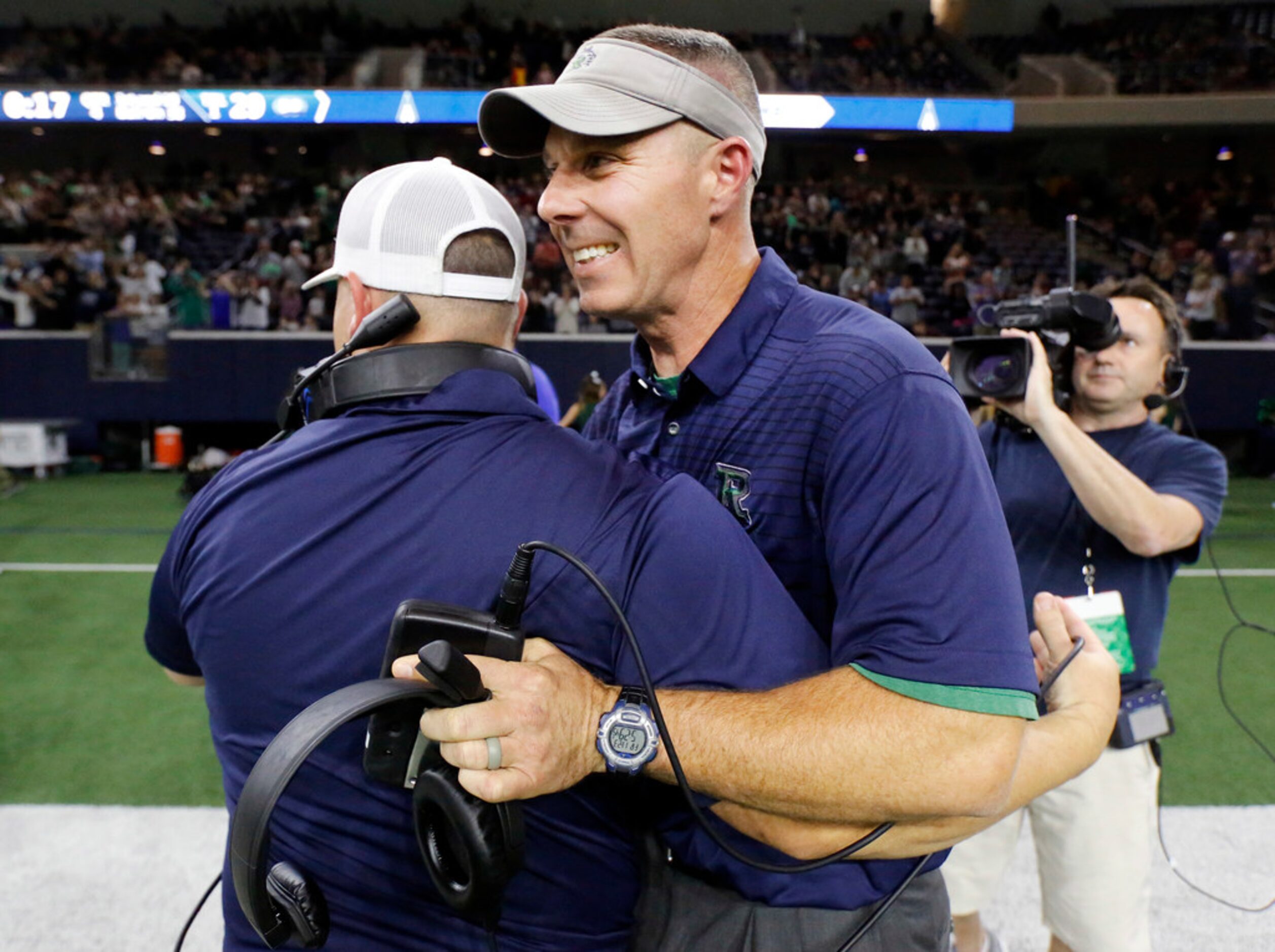 Frisco Reedy head football coach Chad Cole (right) is congratulated by one of his...