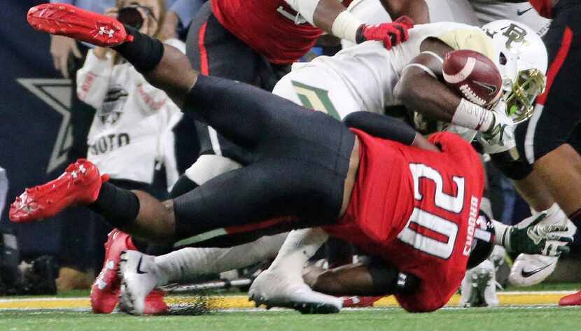 Baylor running back Terence Williams (22) fumbles near the goal line as Texas Tech...