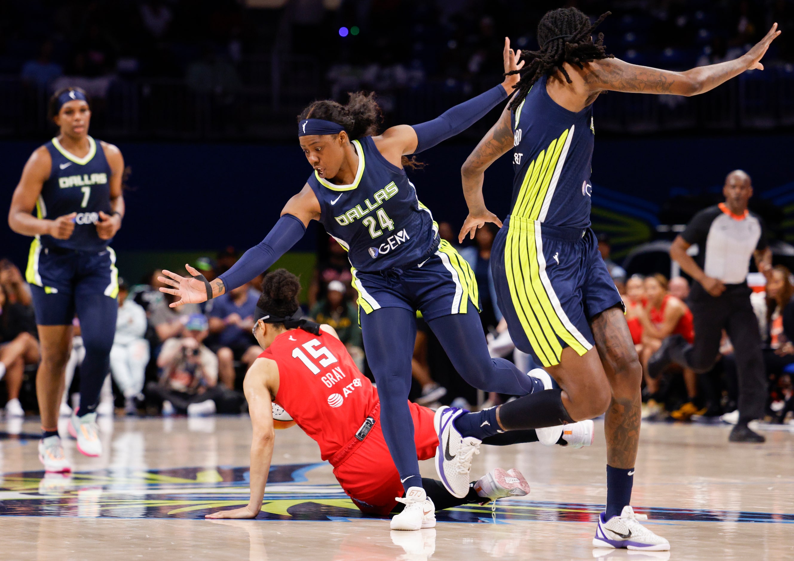 Dallas Wings guard Arike Ogunbowale (24) collides with Atlanta Dream guard Allisha Gray (15)...