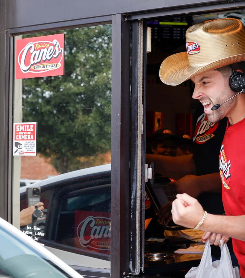 Mayfield reacts to meeting a golden retriever named Baker Mayfield as he works the drive-thru. 