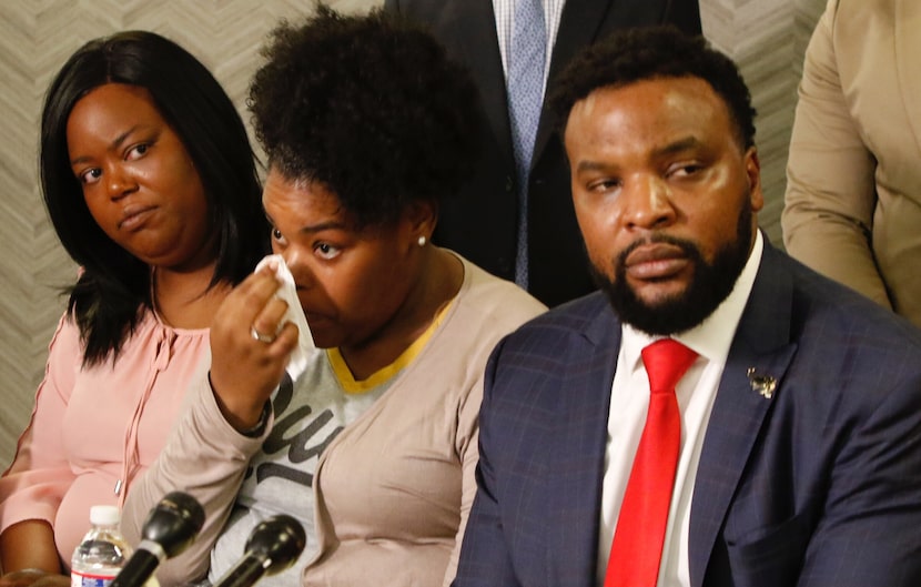 Amber Carr wiped a tear as her sister Ashley Carr and attorney Lee Merritt listen to their...