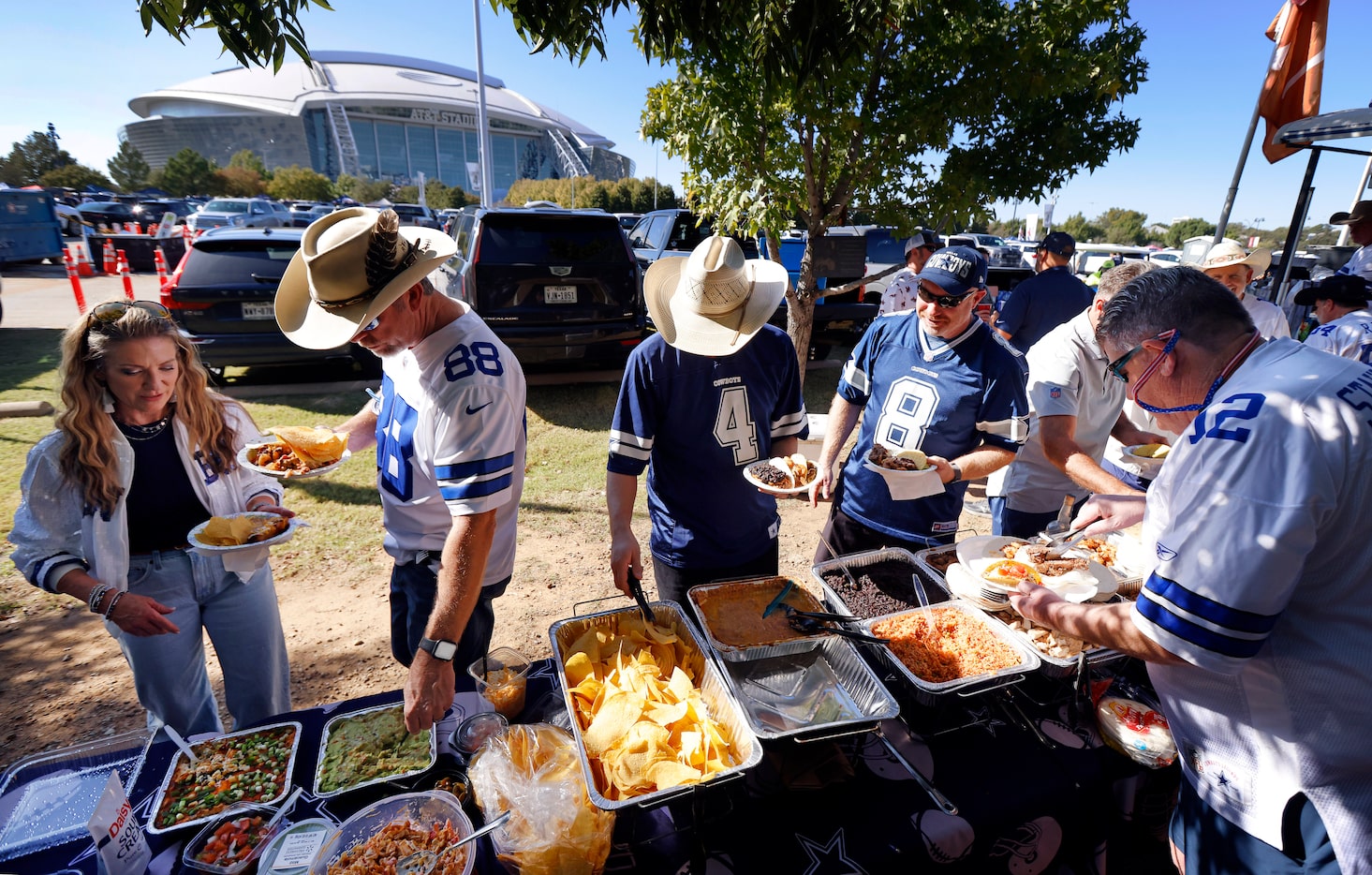 Longtime Dallas Cowboys fans take part in the large Tex-Mex buffet set up by the Lot 4 Gate...