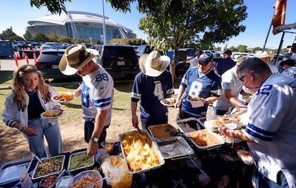 Longtime Dallas Cowboys fans take part in the large Tex-Mex buffet set up by the Lot 4 Gate...