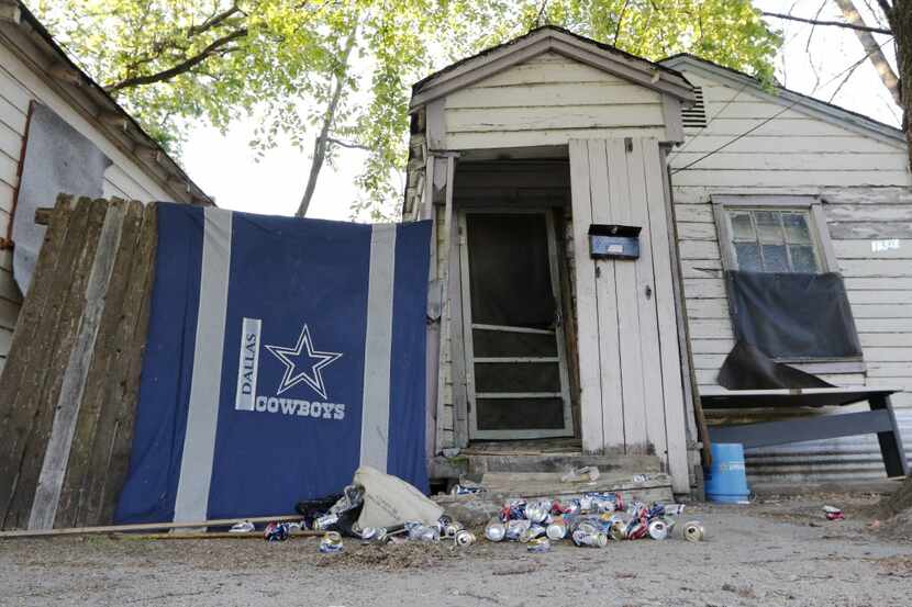  A Cowboys souvenir hangs on a fence at 1320 E. Clarendon Drive, one of six rent houses the...