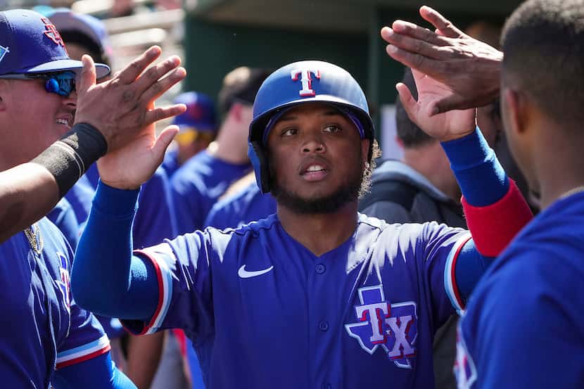 Texas Rangers designated hitter Willie Calhoun celebrates after scoring during the second...