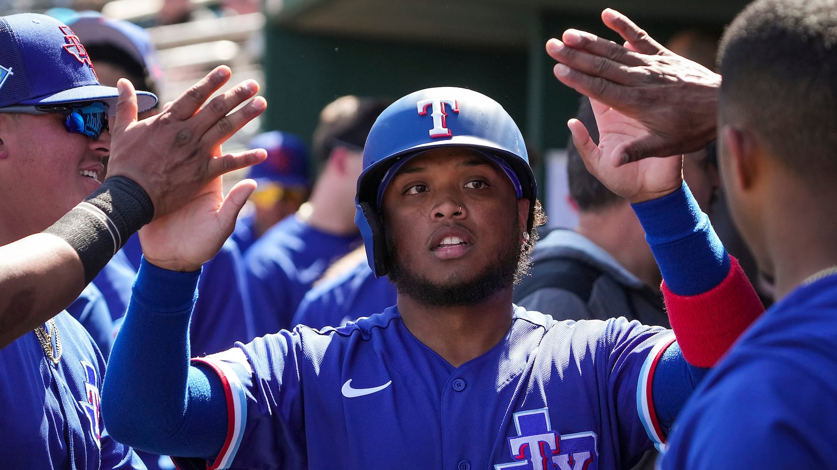 Texas Rangers designated hitter Willie Calhoun celebrates after scoring during the second...