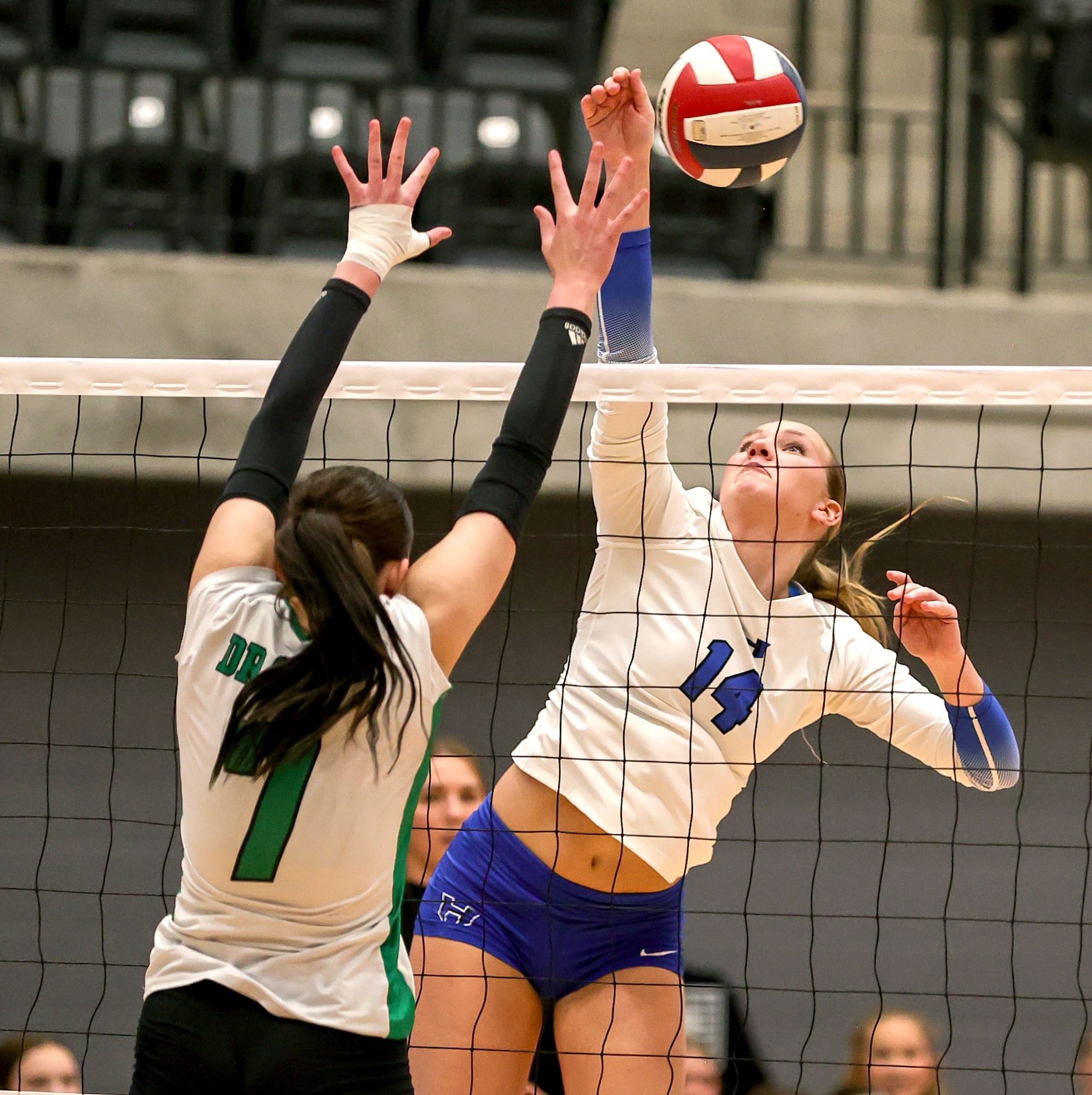 Hebron's Haley Kerstetter (14) attempts a kill against Southlake Carroll's Regan McCullough...