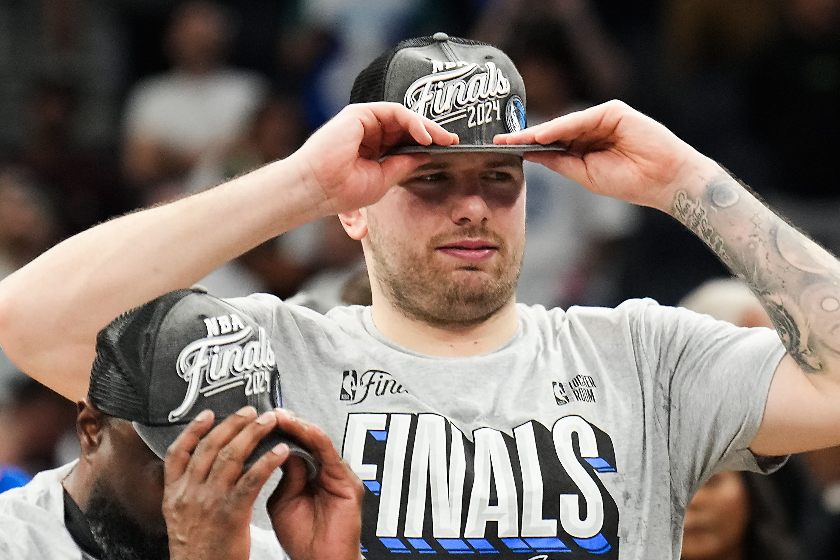 Dallas Mavericks guard Luka Doncic dons a 2024 NBA Finals hat after a victory over the...