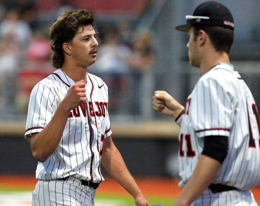 Lovejoy High School pitcher Jack Livingstone (7) is encouraged by team mate Ian Warren (11)...