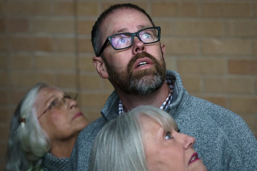 Northway Church lead pastor Shea Sumlin, center, surveys the damage to the sanctuary with KC...