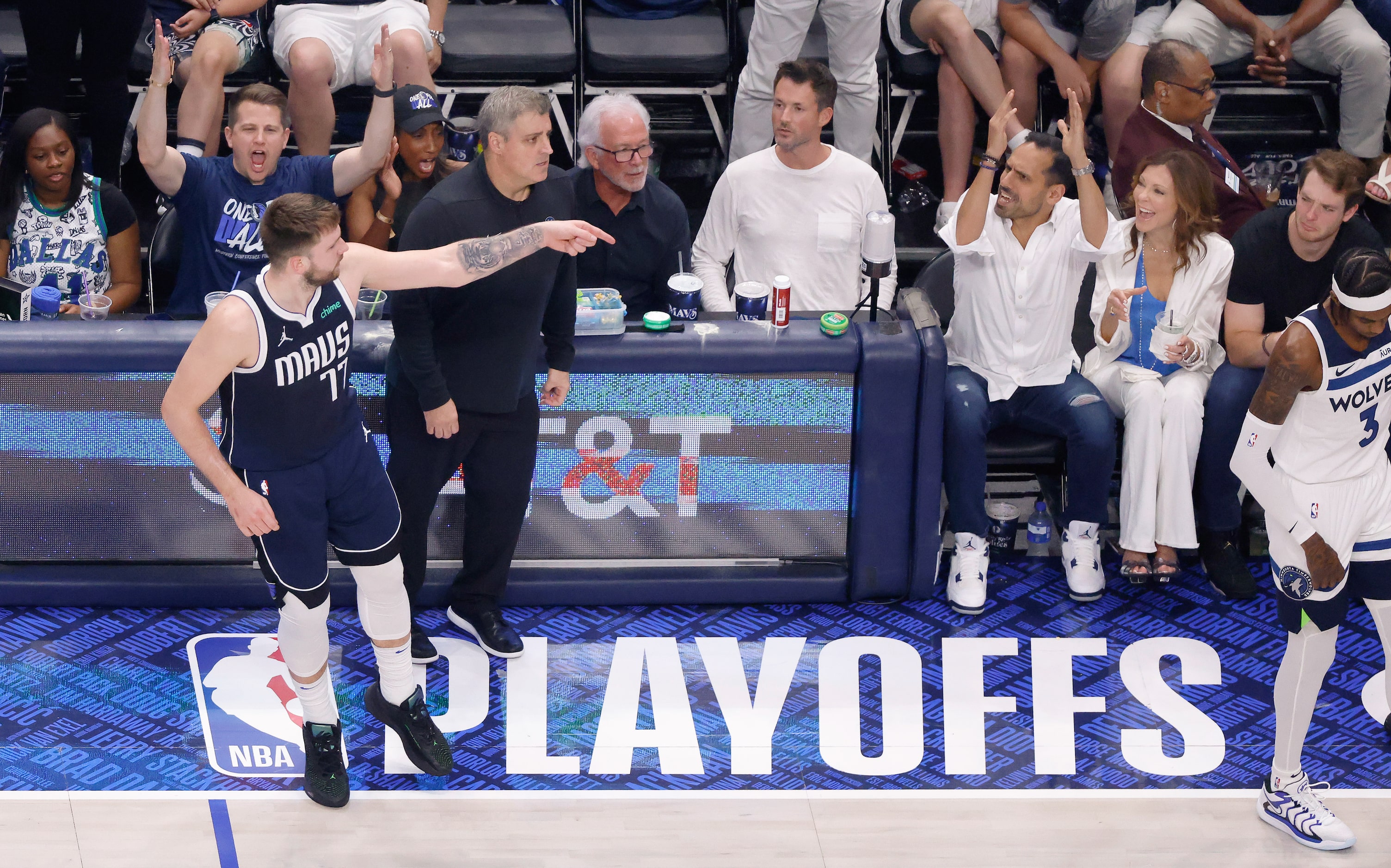 Dallas Mavericks guard Luka Doncic (77) points to the Minnesota Timberwolves bench after...