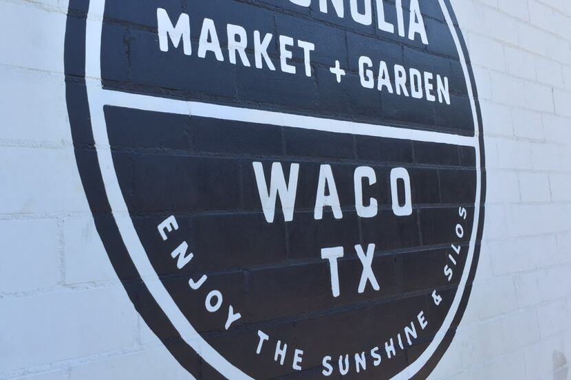 Logo painted on the side of a building at Magnolia Market at the Silos in downtown Waco.