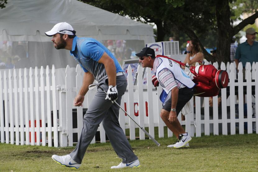 Paul Casey and his caddie, Paul Fusco, look at his drive off the 1st fairway, during the...