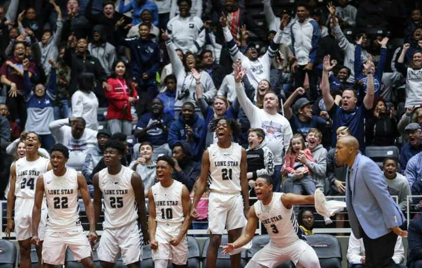 The Frisco Lone Star bench erupts in celebration during the second half a boys basketball...