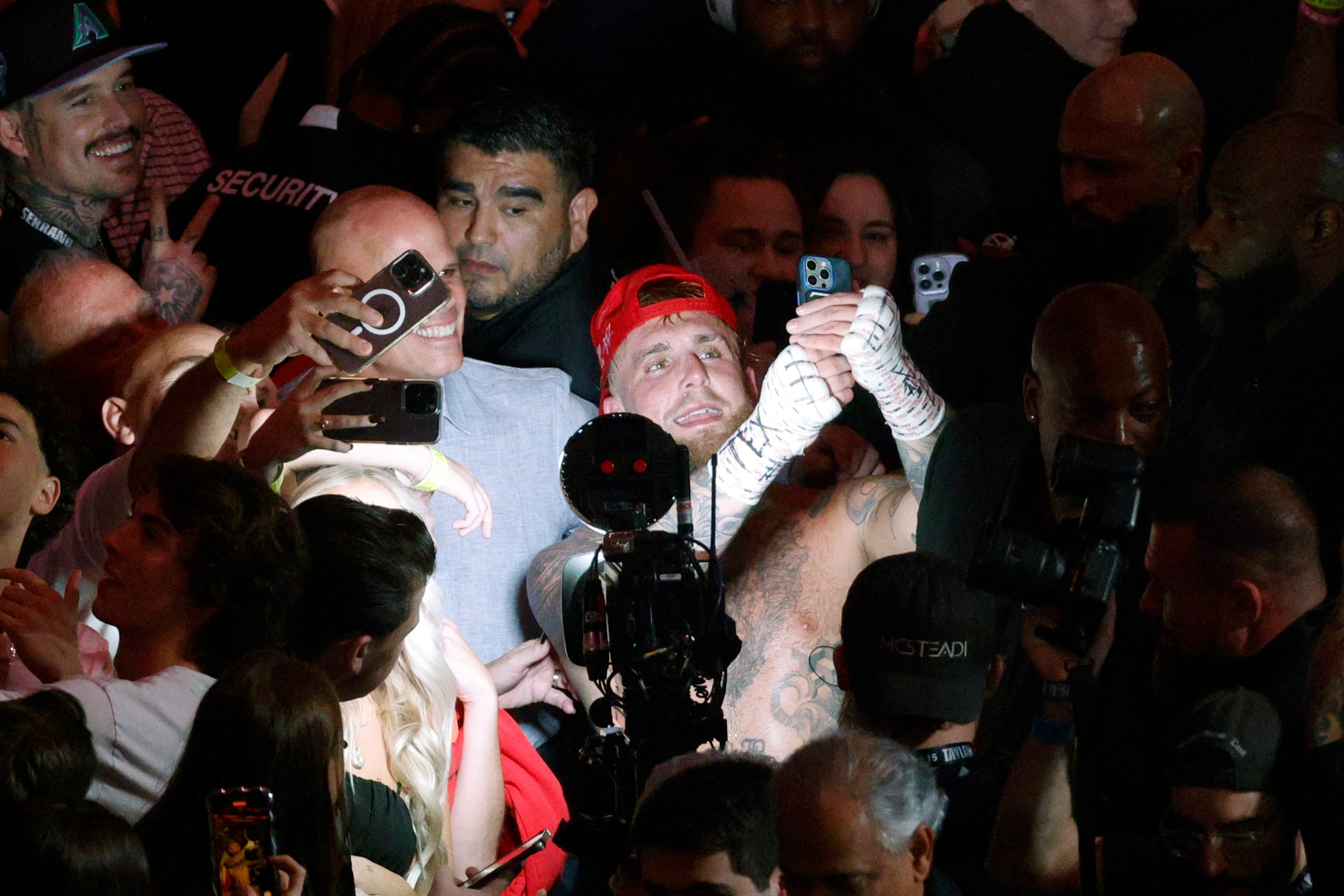 Jake Paul takes a selfie with fans after a heavyweight boxing match against Mike Tyson,...