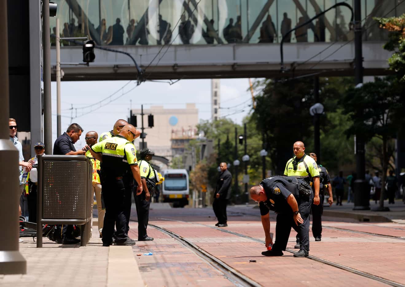 DART police investigate the scene where a Dallas police officer was hit by a DART train near...