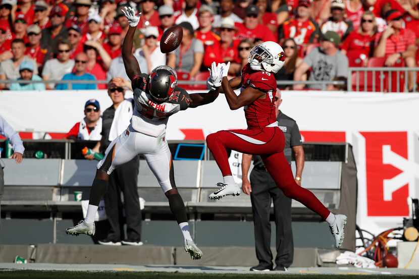 FILE - Buccaneers defensive back Jamel Dean (35) breaks up a pass intended for Cardinals...