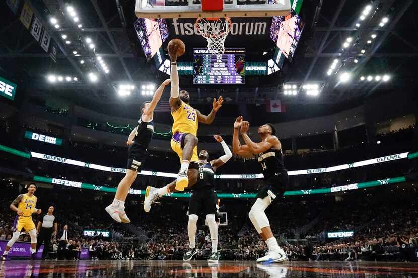 Los Angeles Lakers' LeBron James shoots during the first half of an NBA basketball game...